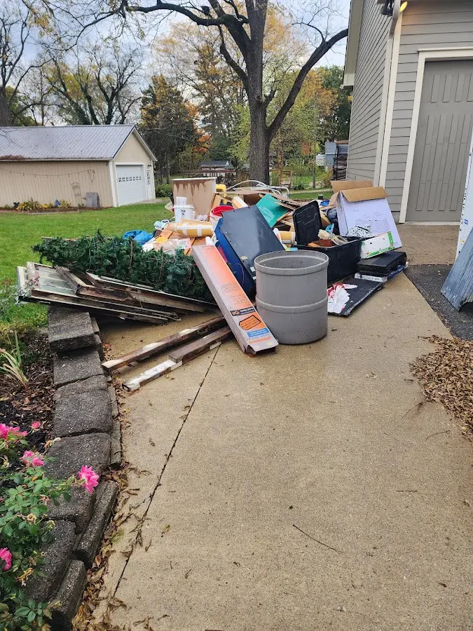 Dumpster being loaded with debris for 12 Yard Dumpster Rental in Calumet